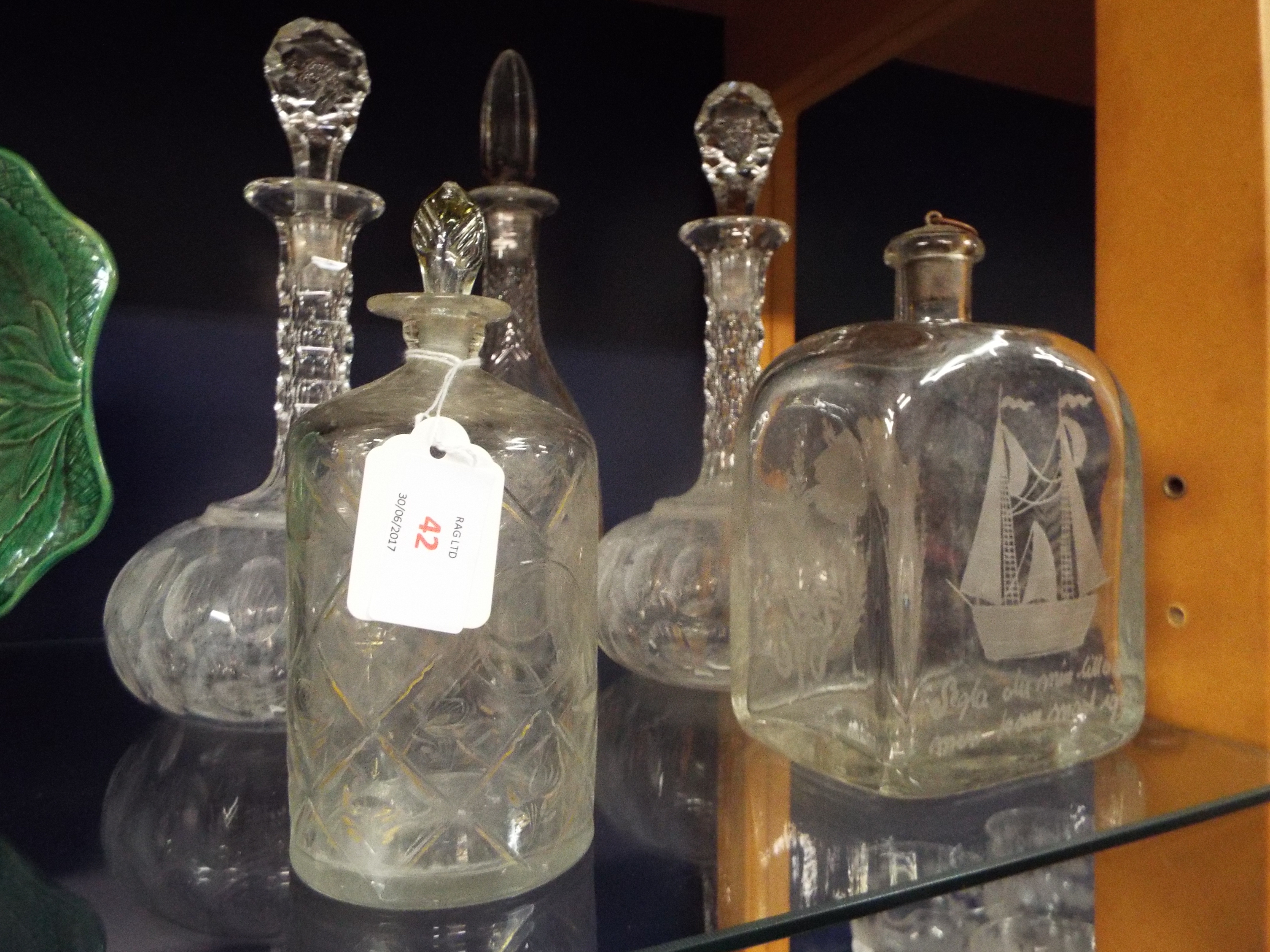 A pair of facet cut glass decanters and three others