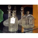 A pair of facet cut glass decanters and three others