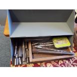 A box of assorted metal working reamer cutting tools of various sizes