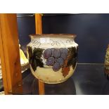 A Royal Doulton Lambeth jardiniere decorated with a band of grapes and vines