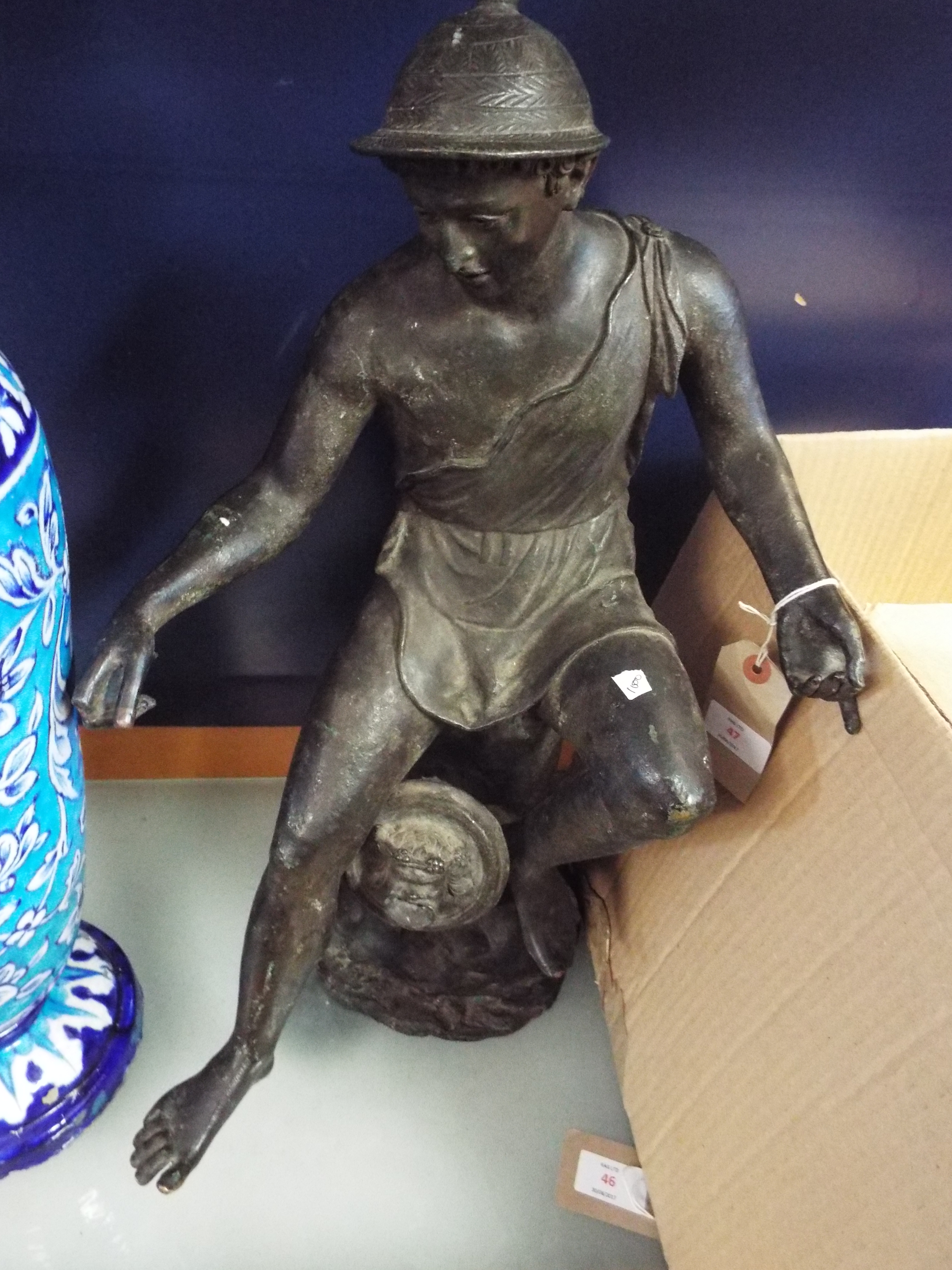 A 19thC patinated bronze figure of a Greek deity seated on a stylised rocky water fountain with