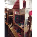 A three story open faced dolls house and accessories