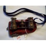 A pair of opera glasses each barrel having floral and leaf decoration