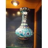 A Victorian turquoise and dark blue tin glazed bottle vase decorated with bands and panels of