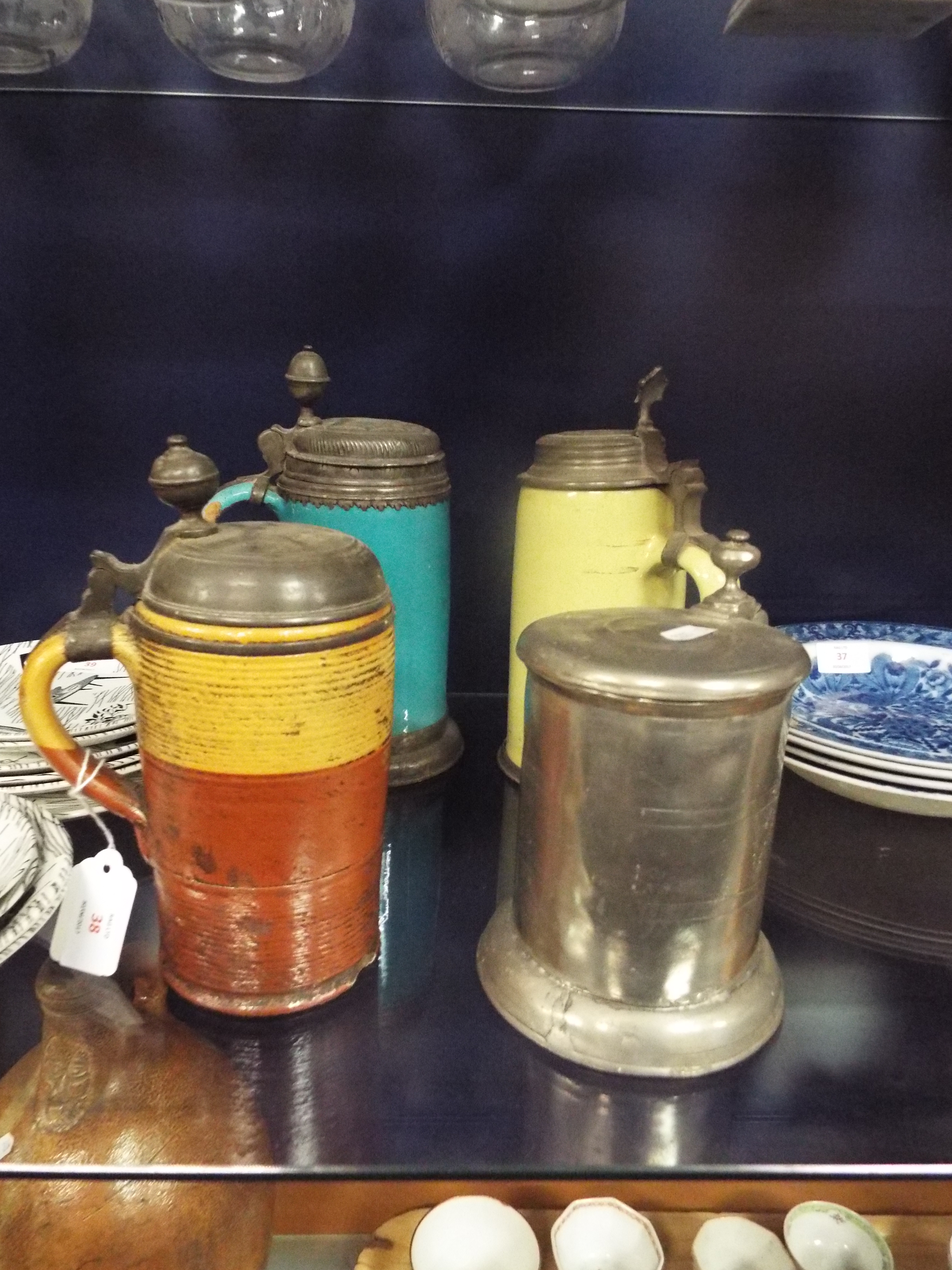 Three antique stoneware and pewter steins and a pewter tankard