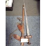 A 19th C Tuareg Ctakouba double bladed sword with leather covered handle and guard and stepped