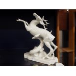 A Herend white glazed figural group of a stag being killed by a snake (A/F) Tip of