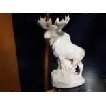 A large USSR white glazed figurine of a moose standing on stylised rocky base