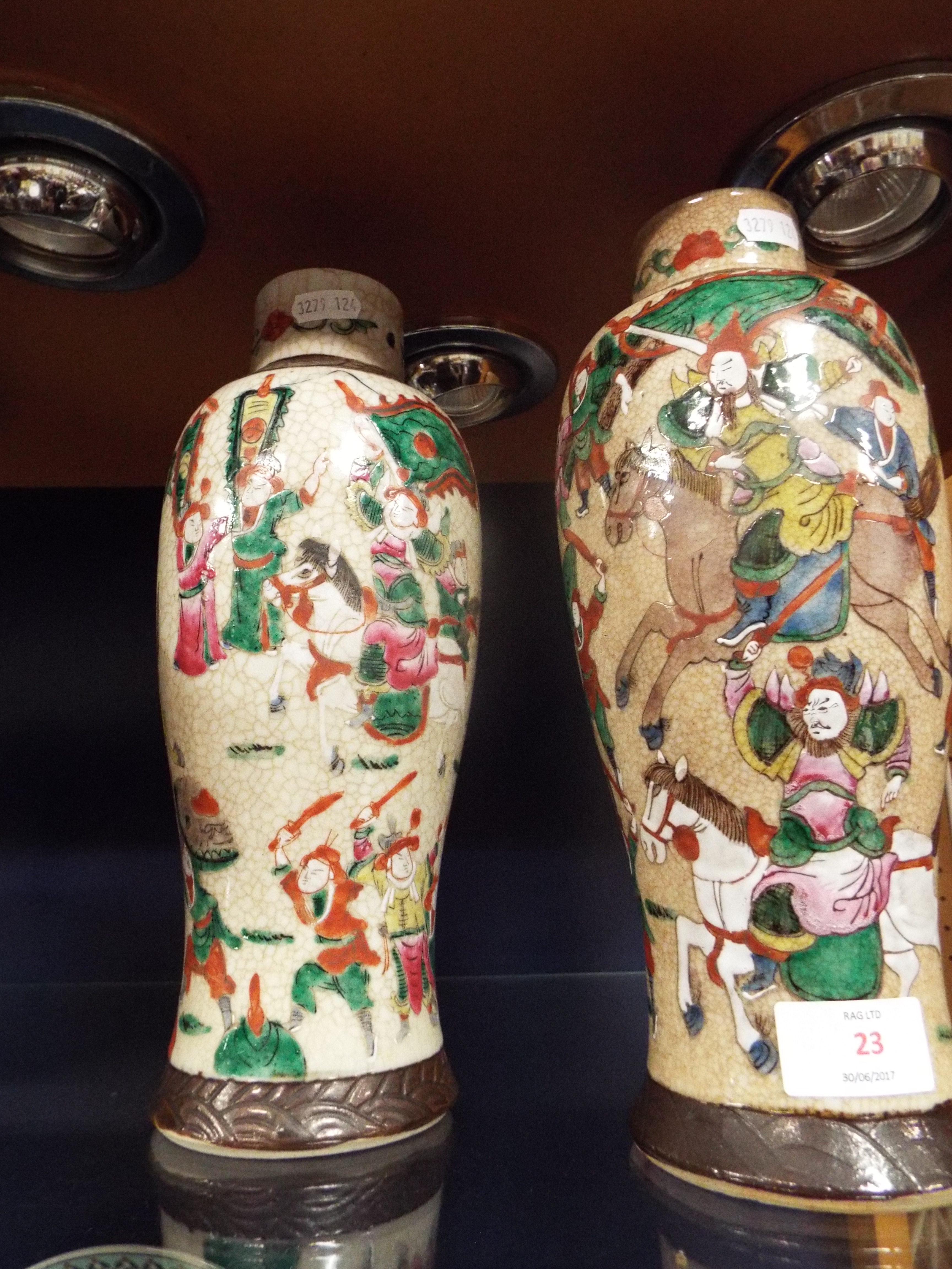 A pair of early 20thC crackle glazed Japanese vases of baluster form enamelled with battling