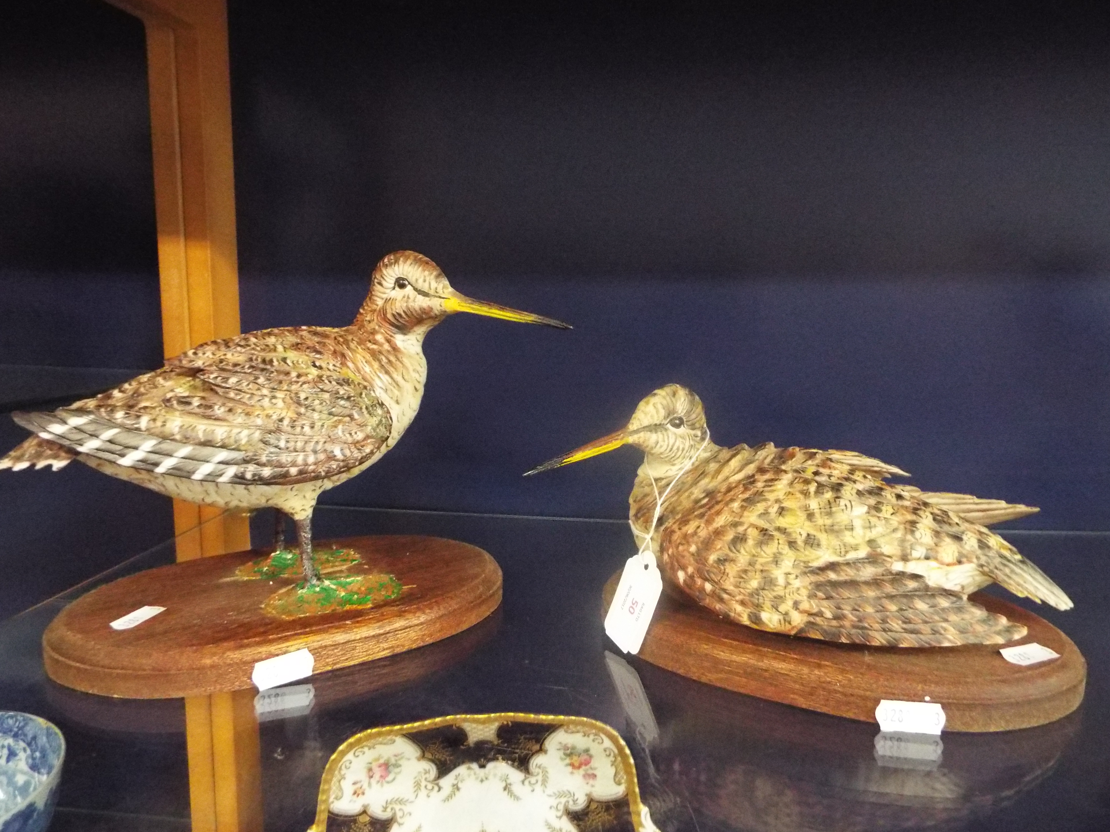 Two Edoardo Tasca for Capodimonte figures of woodcocks resting on wooden bases,