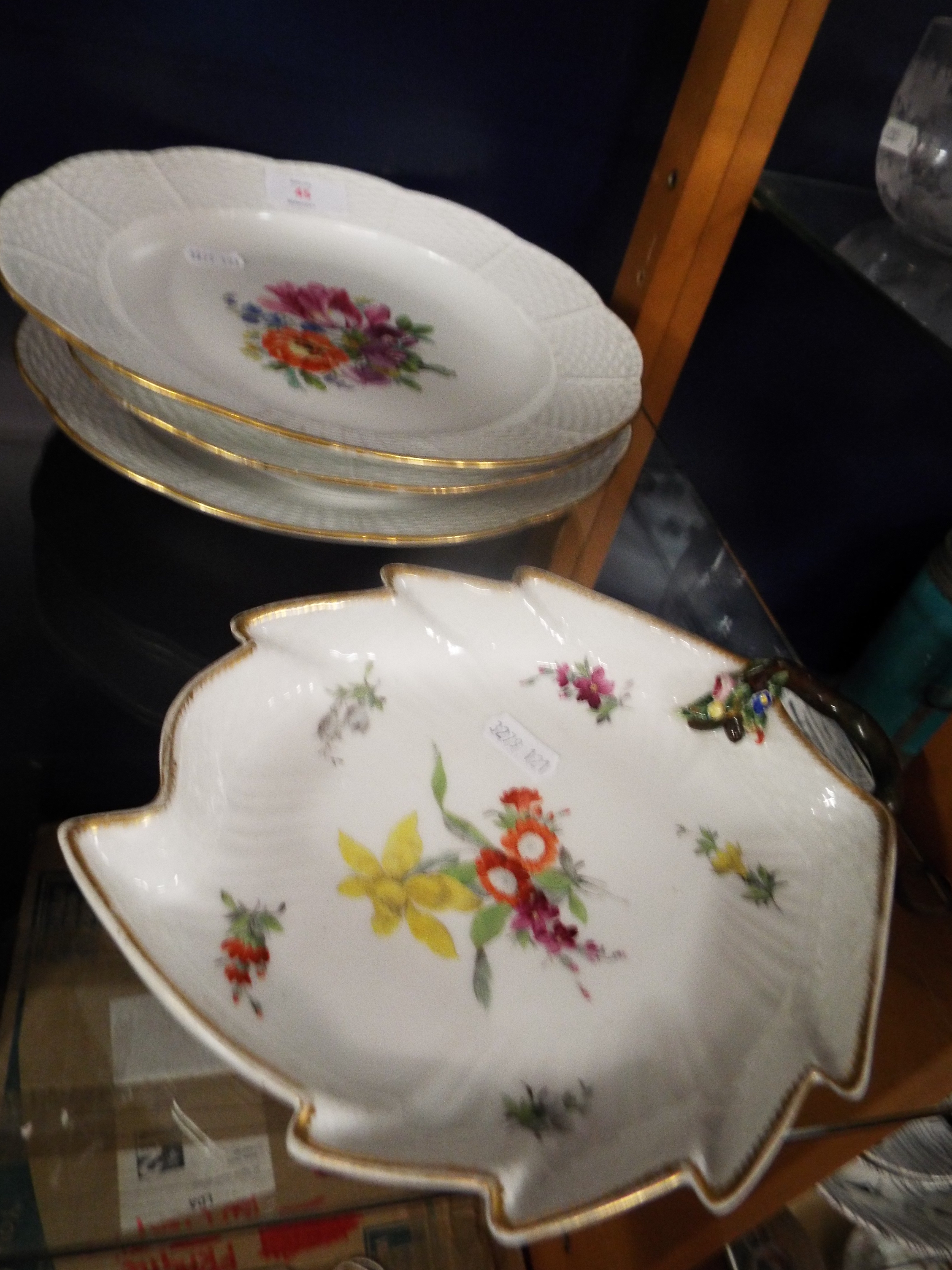 Two Meissen basket weave plates and bowl each hand-painted with central floral sprays and gilt