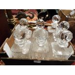 A set of three cut crystal decanters together with two similar pairs
