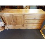 A low pine unit having two drawers and cupboard space