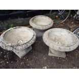 Three reconstituted stone garden urns with egg and dart decoration