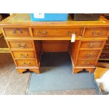 A reproduction yew wood desk,