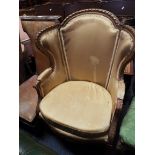 A 19thC French giltwood wingback armchair with carved rope twist frame,