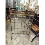 A Victorian brass fire screen with bevelled lead lit glass panel