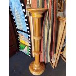 A stained pine fluted jardiniere stand of column form