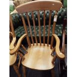 A large lathe back elbow chair raised on turned supports