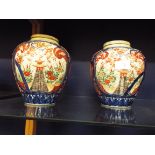 A pair of Oriental lidded ginger jars having mainly blue and red decoration,