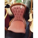 A Victorian style button back nursing chair with serpentine seat raised on squat cabriole supports