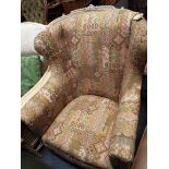 A mid-20thC wingback armchair upholstered with geometric design fabric