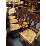 A set of six mahogany chairs and one carver with bergere seats and carved splats