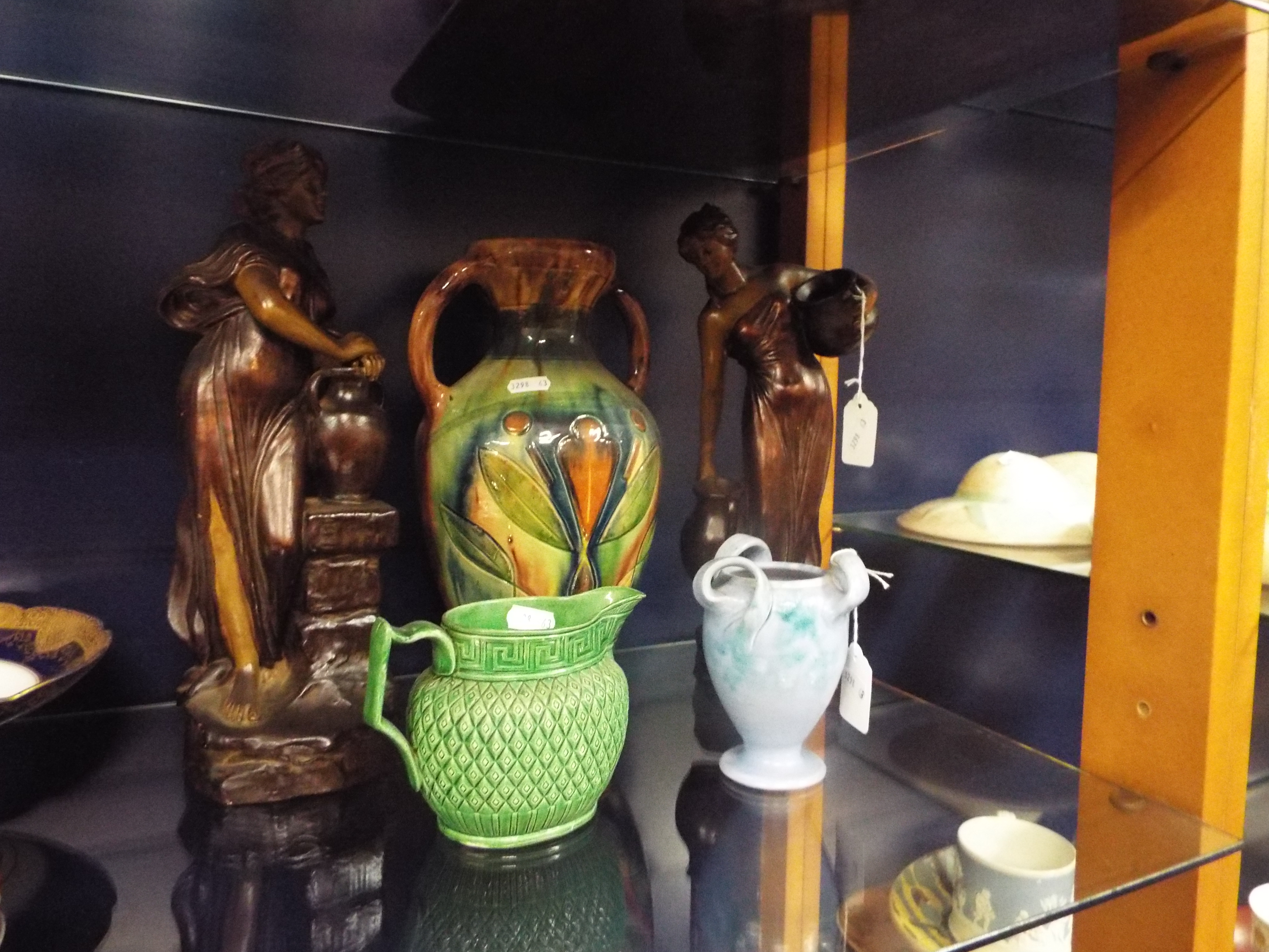 A Barnstaple mottled blue tri-handled vase, a 19thC green glazed Greek key and diamond moulded jug,