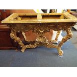 A 19thC Rococo style giltwood console table ornately carved with acanthus and shells and scrolling