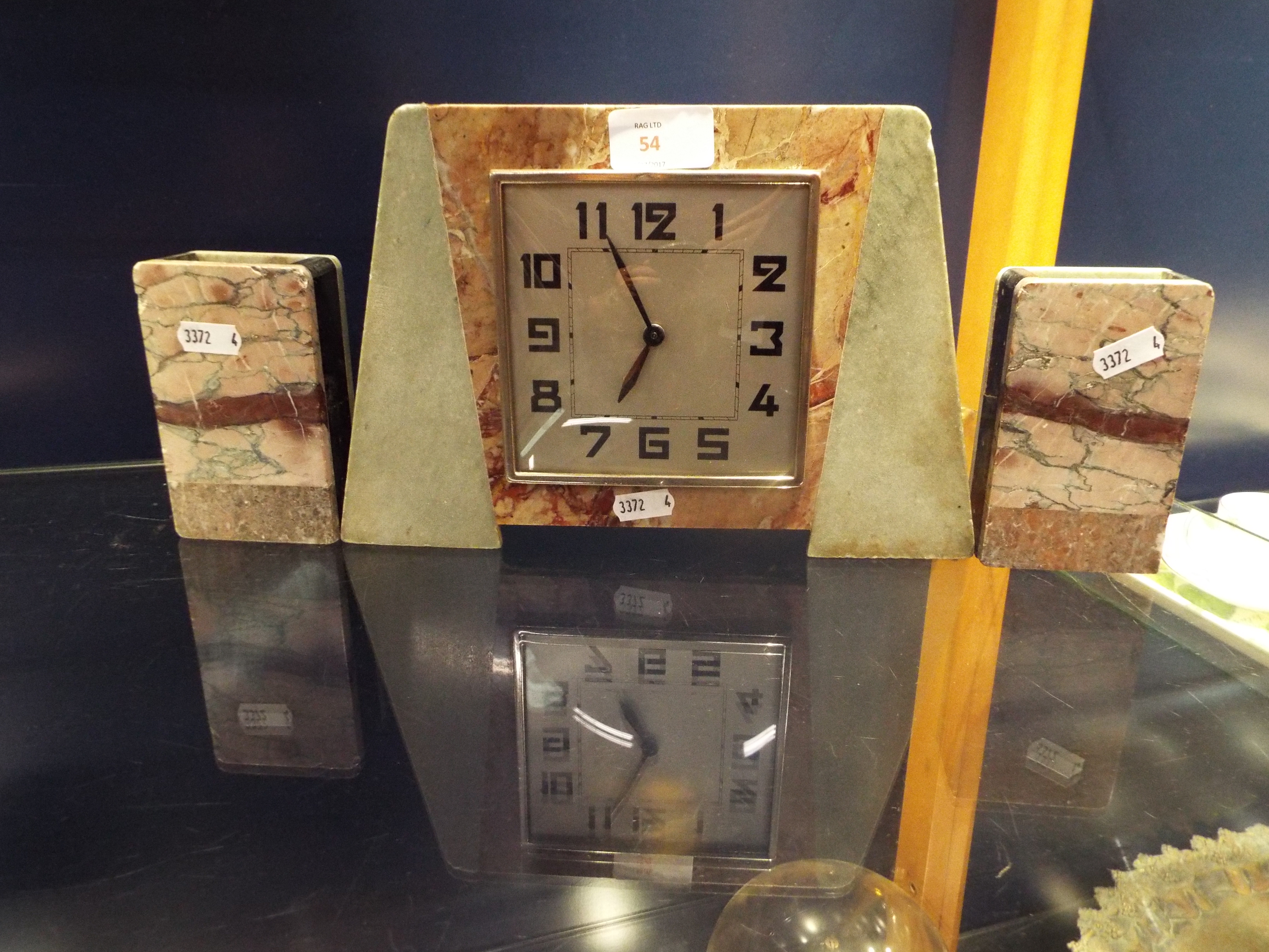 An Art Deco marble clock garniture having Arabic numerals