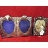 An ornate silver double heart picture frame together with another similar