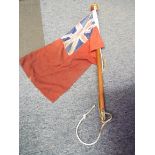 A vintage boating flag depicting a Union Jack on a red background