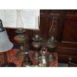 Five Victorian and later copper oil lamps and funnels