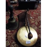 A 1930s brass gong in the form of a German Shepherd together with a vintage hand bell with turned