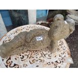 A concrete garden figure of a reclining teddy bear