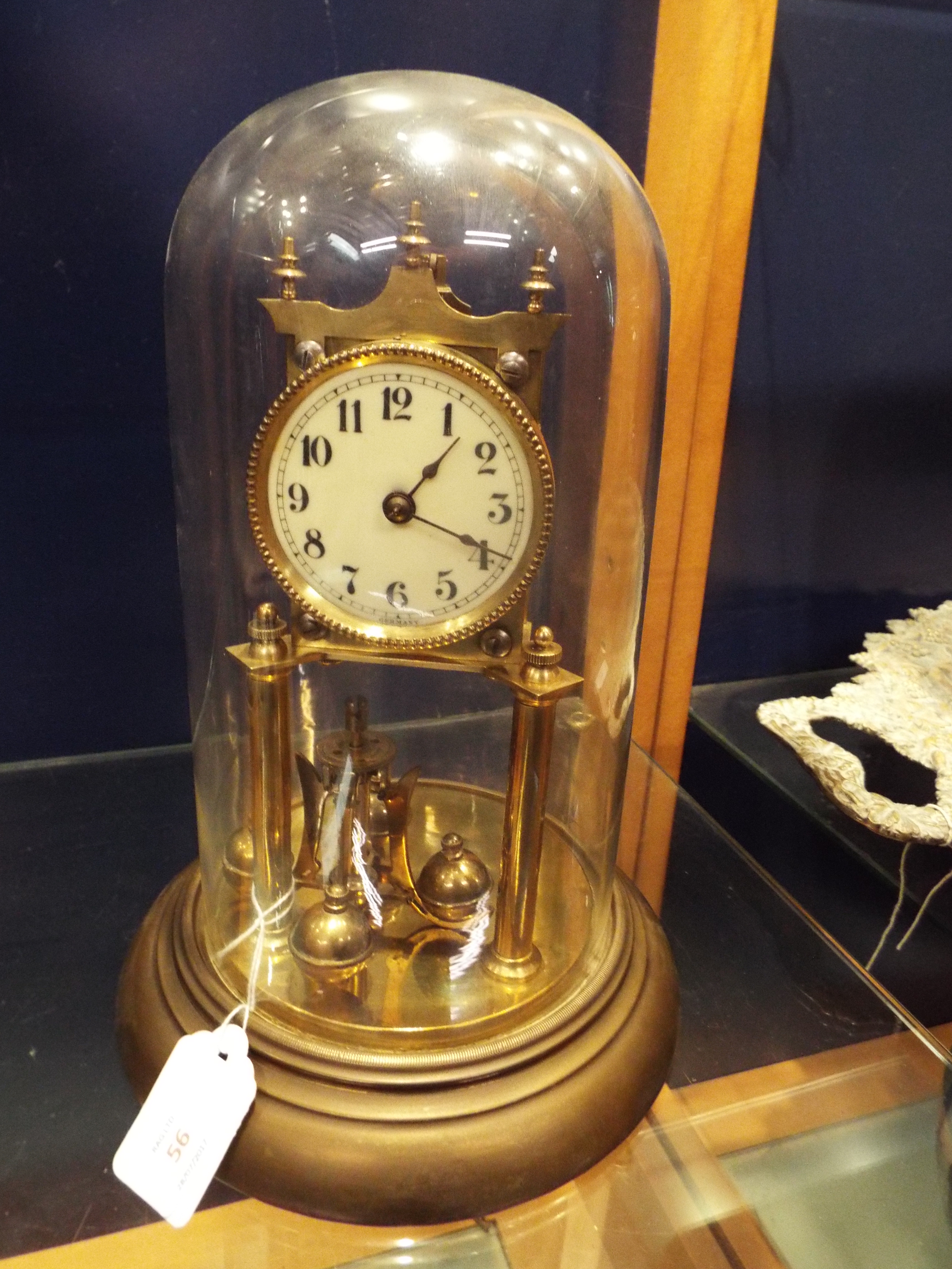 An early 20thC German gilt brass torsion clock with enamel dial and Arabic numerals, no.