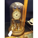 An early 20thC German gilt brass torsion clock with enamel dial and Arabic numerals, no.