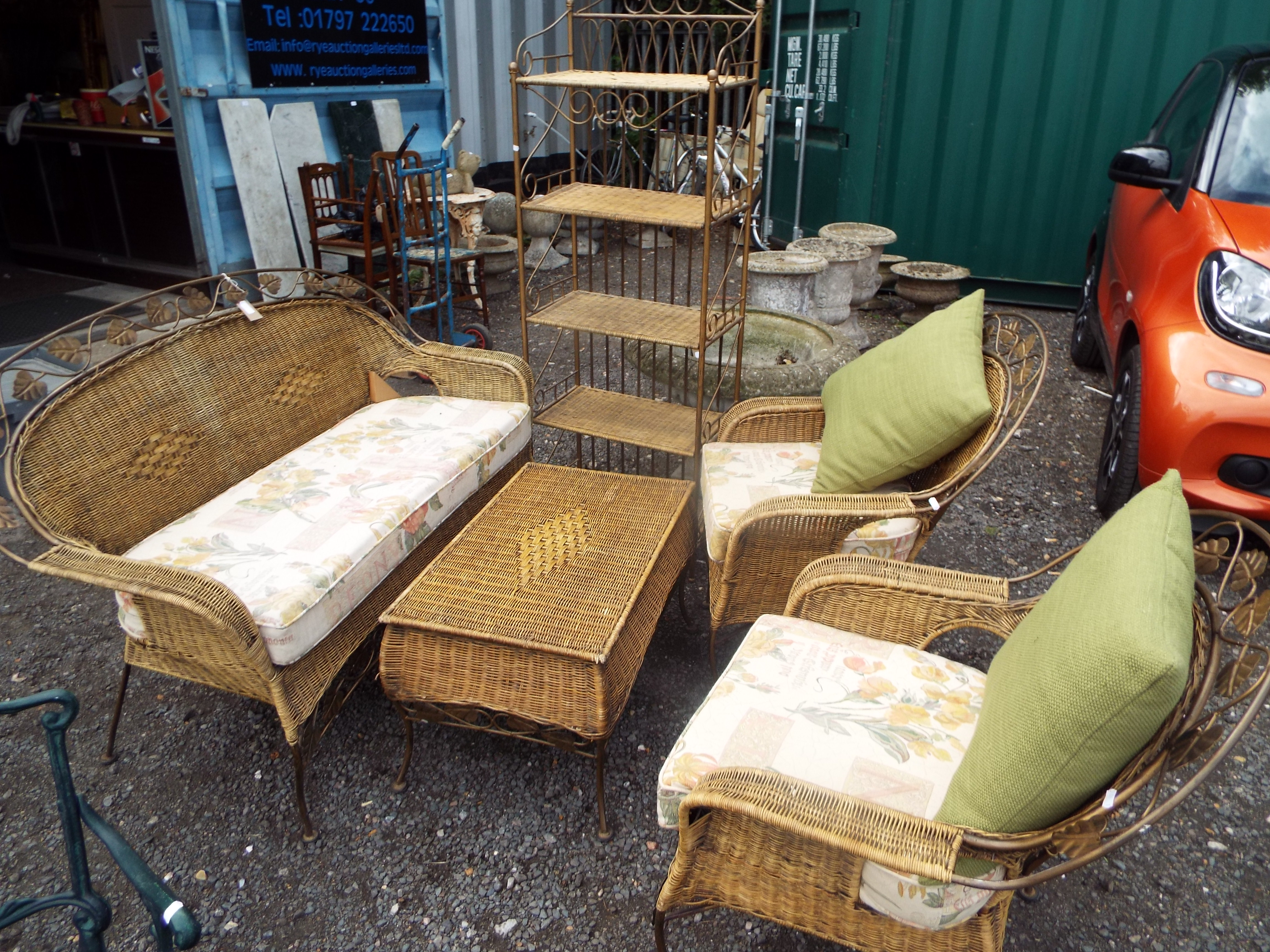 A gilt metal and wicker conservatory suite comprising of settee, two armchairs,