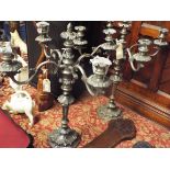 A pair of very ornate silver plated four branch candelabra with acanthus leaf sconces and fan leaf