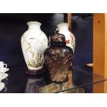 Two Franklin Porcelain bird vases on wooden stands together with a Japanese black glazed lidded