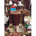 A pair of brass table lamps in the form of Corinthian columns