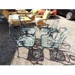 A set of four green painted metal garden chairs