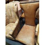 A Victorian prie-dieu chair upholstered in tan leather and raised on mahogany turned supports