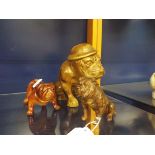 A WWII ceramic figure of a bulldog with helmet inscribed 'Hitler's Terror' together with an