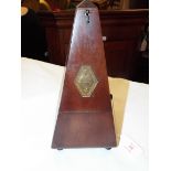 An early 20thC French mahogany cased metronome by Maelz El Paquet