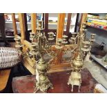 A pair of ornate Georgian style five branch candelabra of urn shape form