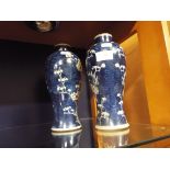 A pair of blue and white baluster shaped vases decorated with prunus,