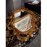 An ornate cartouche shaped gilt wall mirror (A/F)