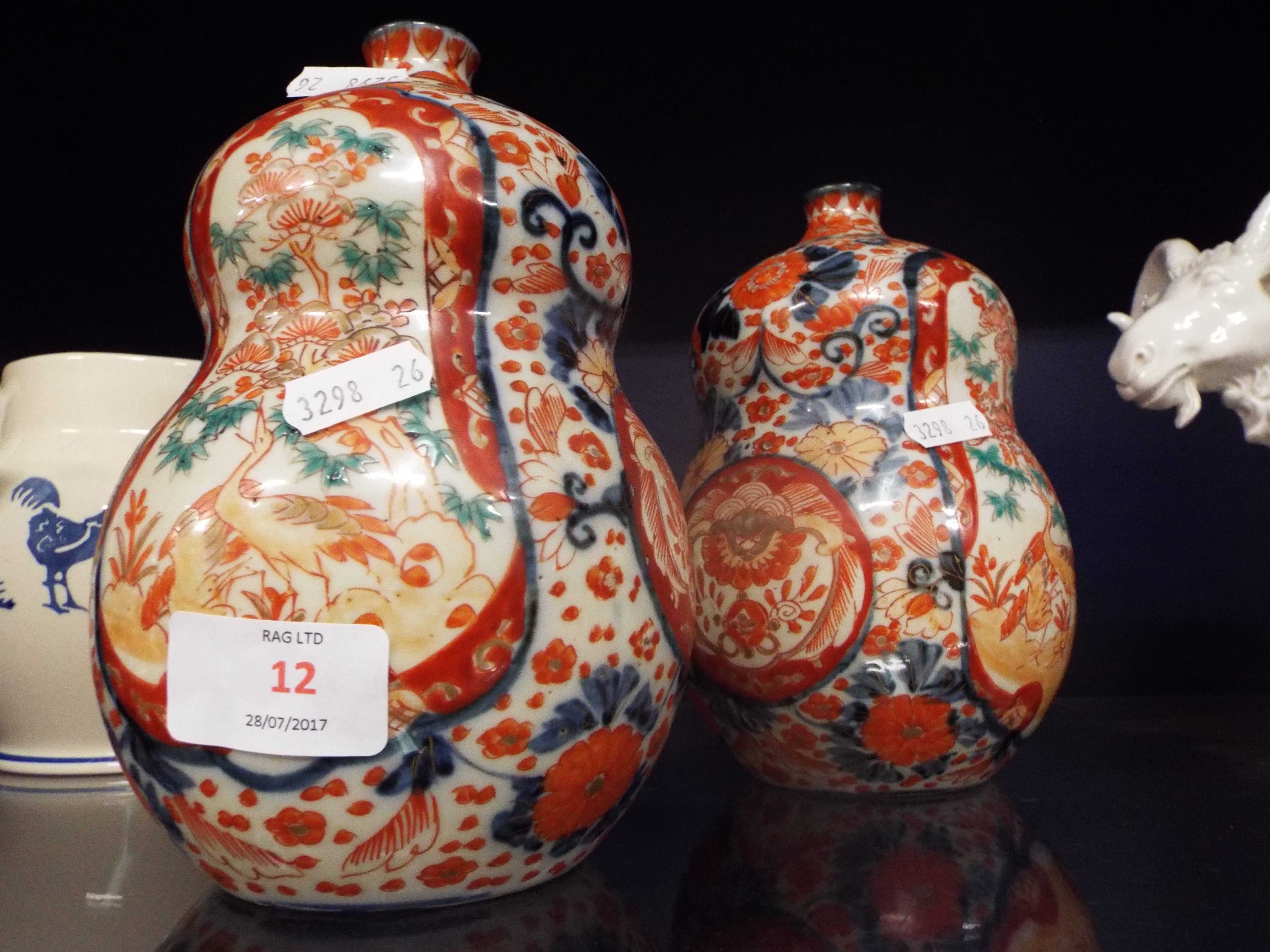 A pair of early 20thC Oriental double gourd vases having bird and foliate decoration