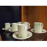 A set of six Rye Pottery coffee cans and saucers with green stripe pattern